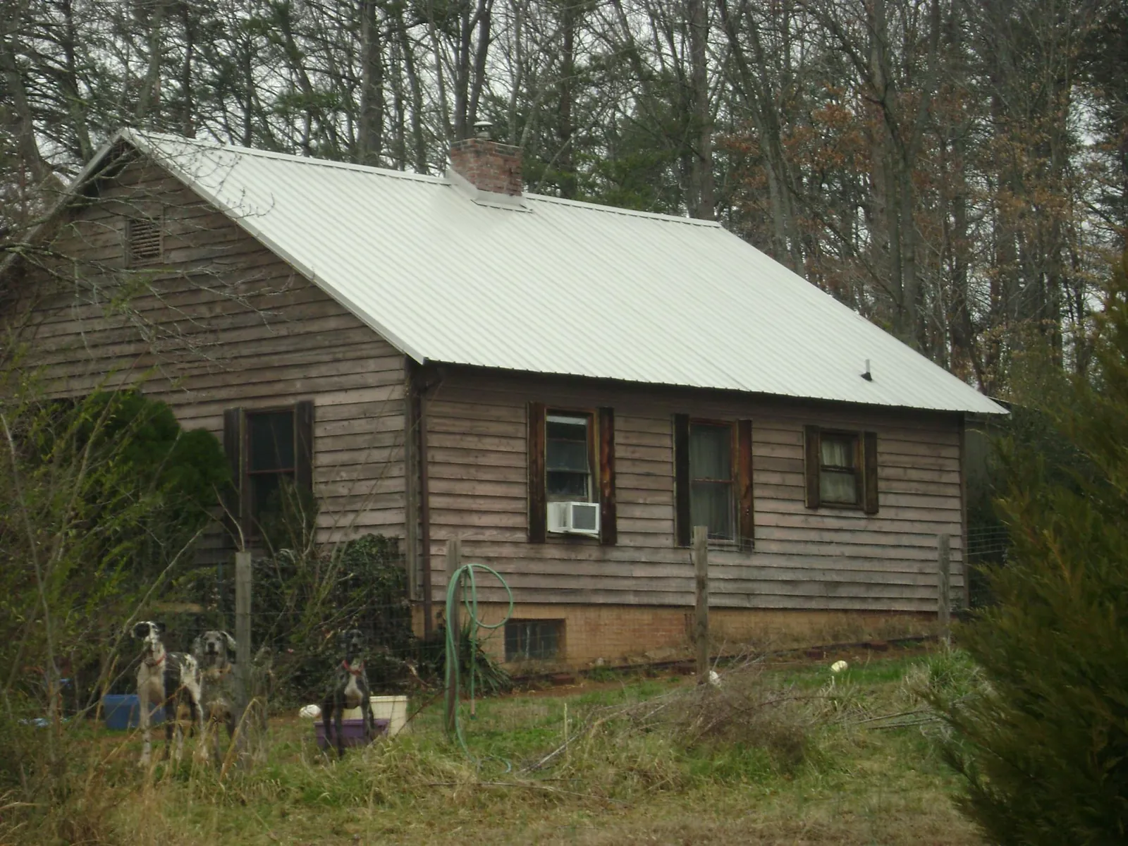 White metal roof on an old wood sided farmhouse, from a Metal Roof Installation job in Bow